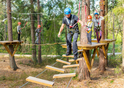 Family trying out an educational adventure track in Skypark Vaxholm.