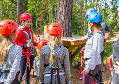 A Skypark instructor teaching the visitors the safety system for the adventure track.
