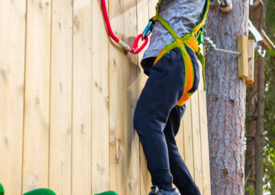 Little girl on a climbing wall in adventure park Skypark Vaxholm.